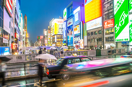 Motion blur of Japanese people travelling through Dotonbori area of Osaka