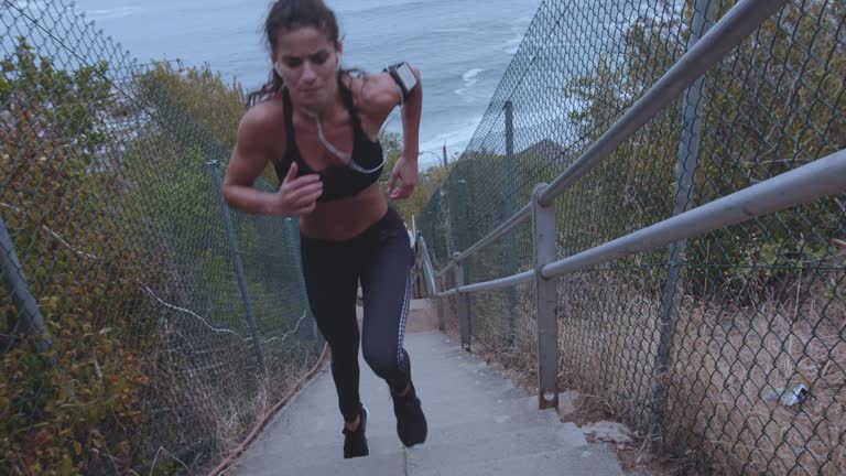 Female athlete climbing up the steps