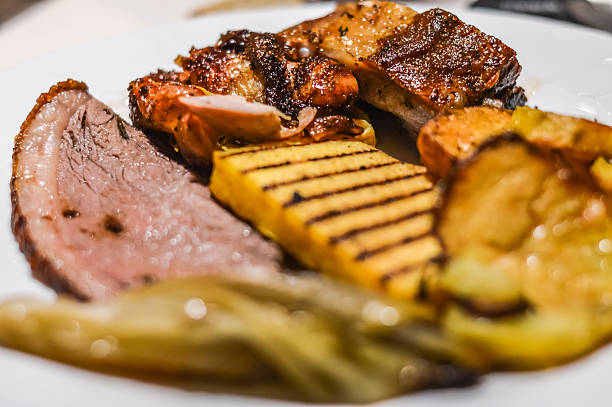 istock dish with roasted beef, pork, polenta and vegetables 578792644