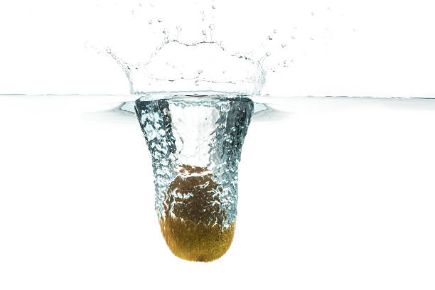 istock Kiwi in water splash, isolated on white background 578793688
