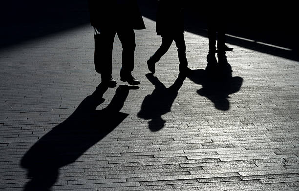 istock Low angle view of three people walking walkway 578796812
