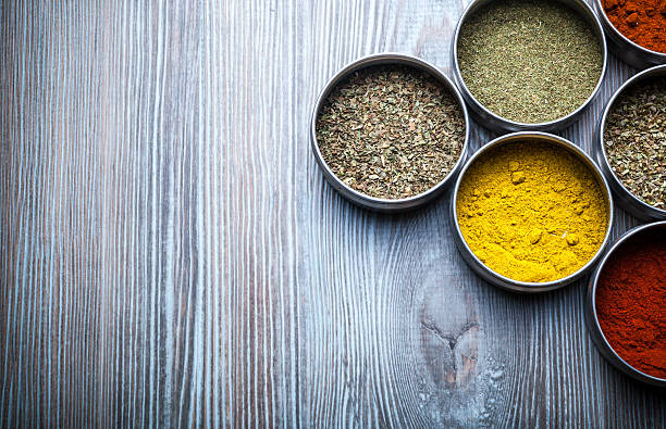 istock Spices and herbs in metal containers on wooden table 578797052