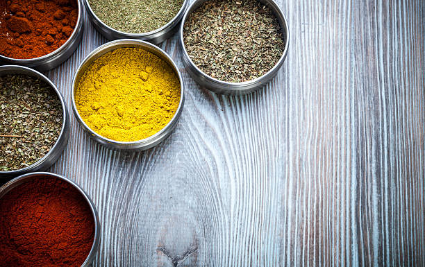 istock Spices and herbs in metal containers on wooden table 578797150