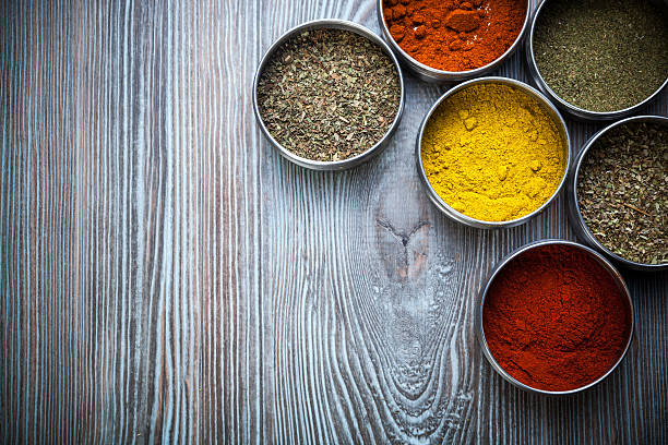 istock Spices and herbs in metal containers on wooden table 578797256