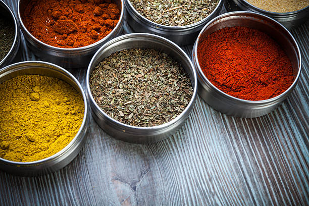 istock Spices and herbs in metal containers on wooden table 578797540