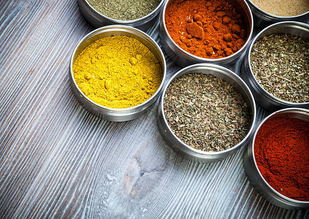 istock Spices and herbs in metal containers on wooden table 578797616
