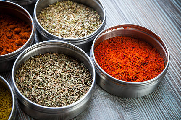 istock Spices and herbs in metal containers on wooden table 578797756