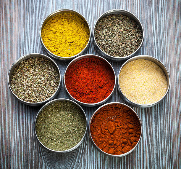 istock Spices and herbs in metal containers on wooden table 578798072