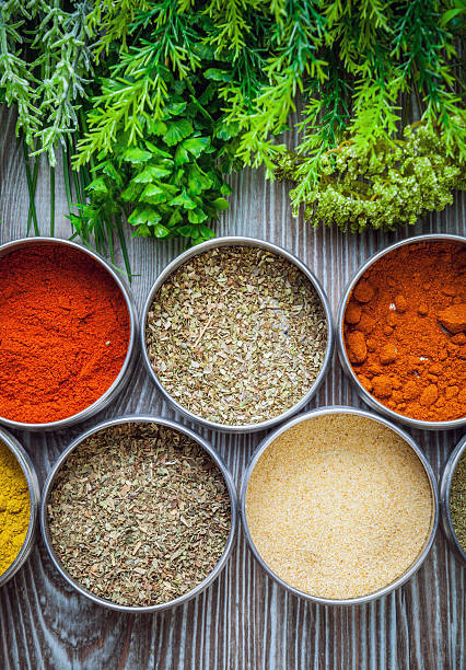 istock Spices in metal containers and fresh herbs on wooden table 578798832