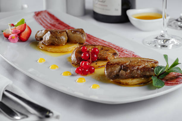 istock meat on potato slices with currant, sauce on white plate 578799020