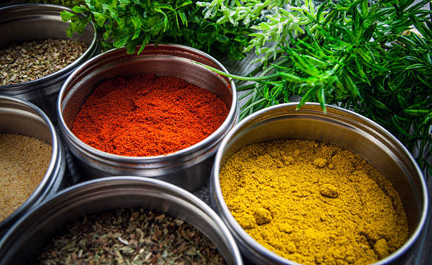 istock Spices in metal containers and fresh herbs on wooden table 578799206