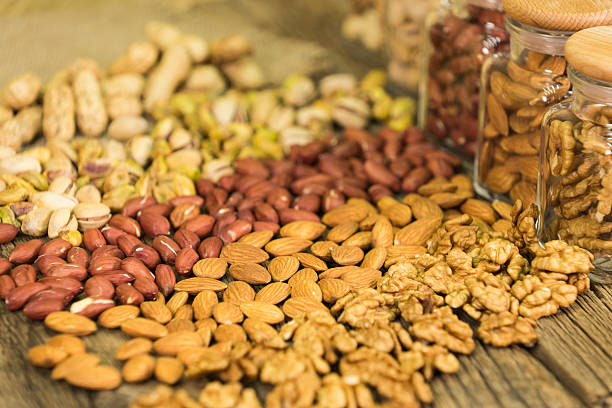 istock Mix of nuts in the glass jars , on the table 578799310