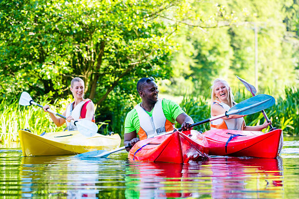 istock Friends paddling with canoe on forest river 578800922