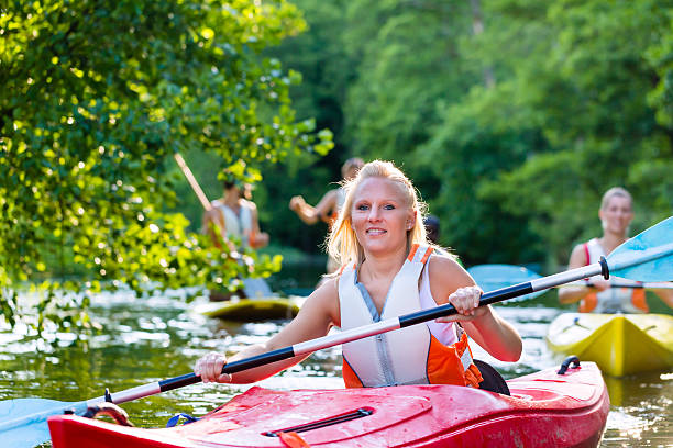 istock Friends driving with kayak on forest river 578801080