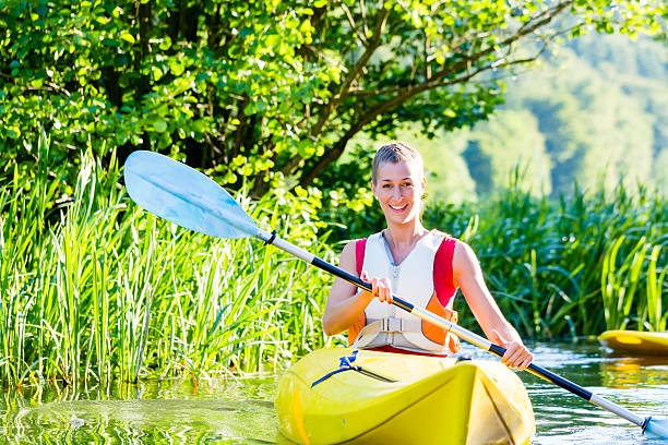 istock woman with kayak or canoe on forest river 578801206