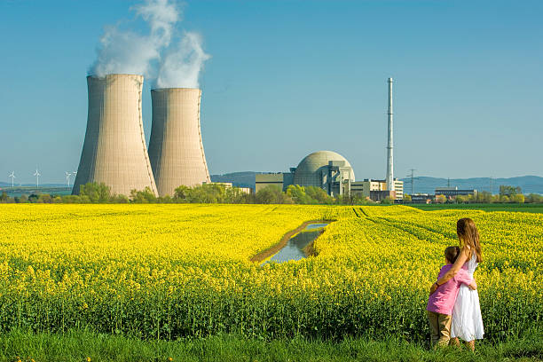 istock Mother embracing Son in Front of Nuclear power station 578801840