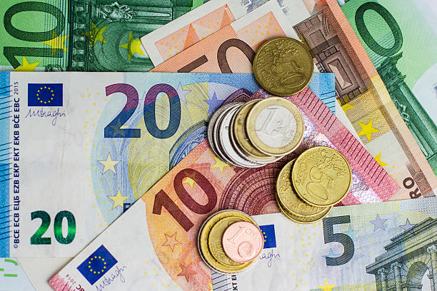 euro bills and coins - cash money euro bills and coins - cash money euro symbol stock pictures, royalty-free photos & images