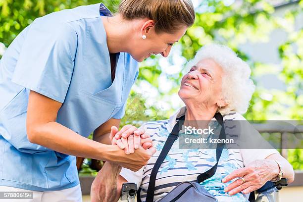 Nurse Holding Hand Of Senior Woman In Pension Home Stock Photo - Download Image Now - Senior Adult, Nursing Home, Nurse