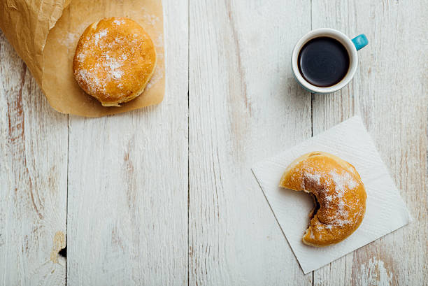 bismarck donut on wooden table in paper - bismarck donuts imagens e fotografias de stock