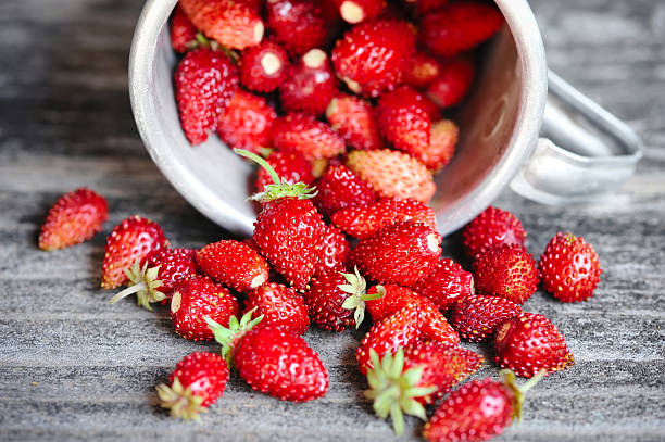 istock Fresh wild strawberries on an old wooden table 578808676