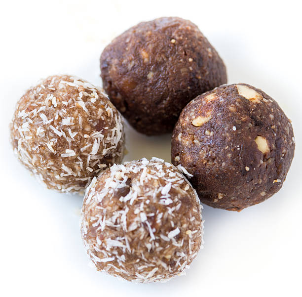 Gluten Free Homemade dates and coconut nutrition energy balls Gluten Free Homemade dates and coconut nutrition power balls plasma ball stock pictures, royalty-free photos & images