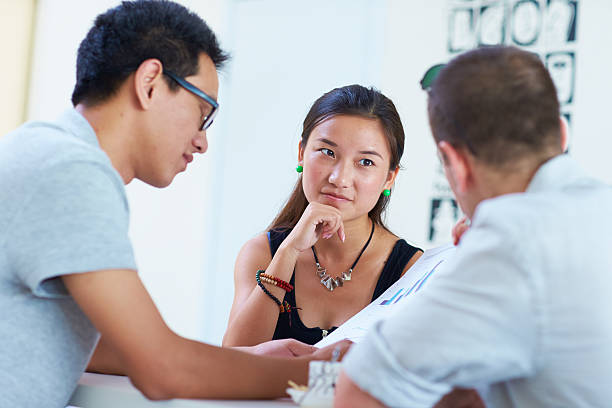 istock three business people having meeting together 578809874