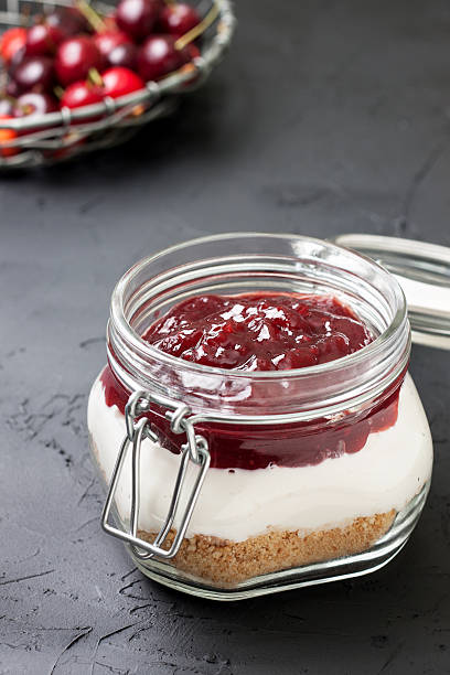 istock cheesecake in a glass jar with cherries 578810188