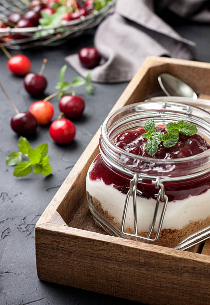 istock cheesecake in a glass jar with cherries 578810834