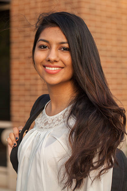 Smiling female young college student of Indian ethnicity stock photo