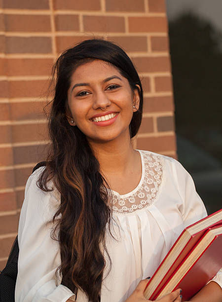 Smiling female young college student of Indian ethnicity stock photo