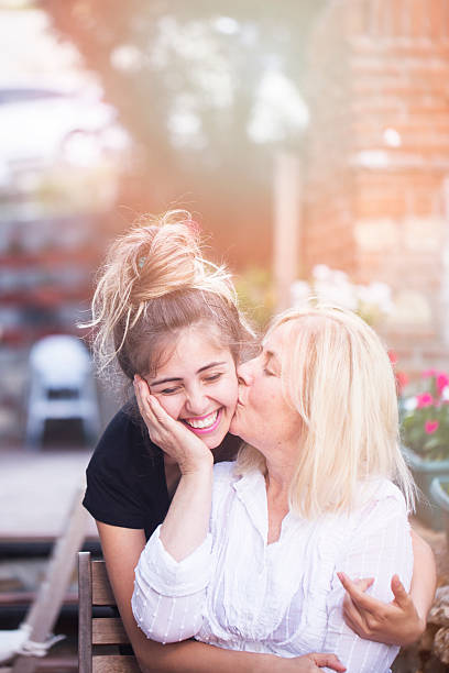istock Mother kissing her daughter 578811776