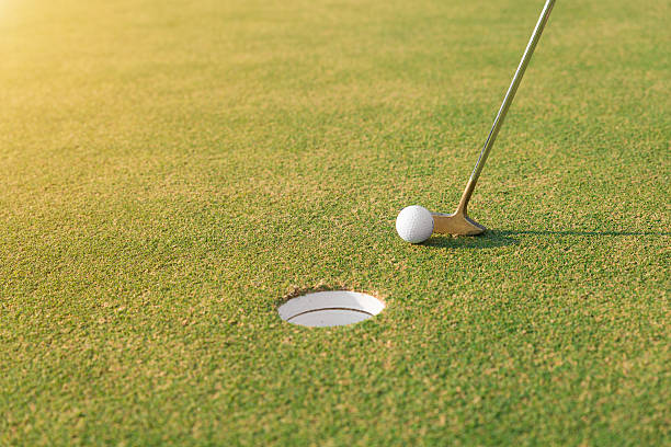 istock Golf player at the putting green hitting golf ball. 578813186