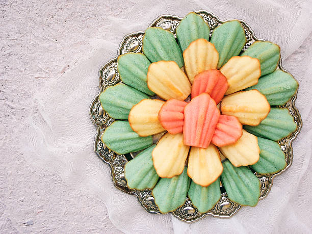 blue, pink and yellow pastries. French Madeleine cakes