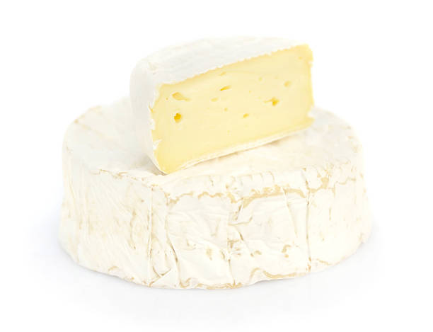 istock Round camembert cheese with a piece on white background 578817520
