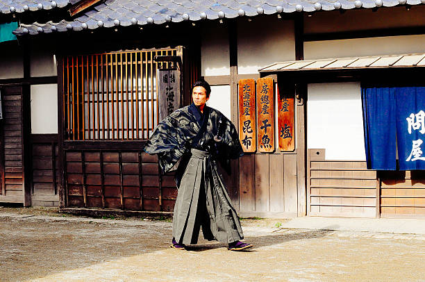 Portrait of samurai in empty street in traditional Japanese village, in sunny afternoon. Image taken in TOEI studio Kyoto, Japan