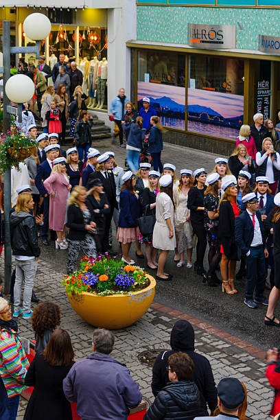 Akureyri, Iceland - June 17, 2016: Locals and visitors attend the Independence Day parade in the main street of Akureyri, Iceland
