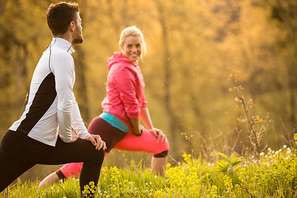 personal trainer and female client doing stretch exercise - playing field determination exercising relaxation exercise imagens e fotografias de stock