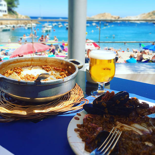 istock Spanish paella restaurant on a blue beach shore 578822534