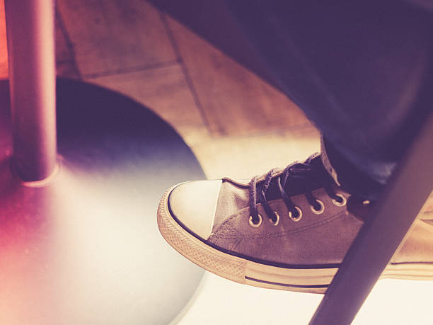 istock Young girl's feet with canvas shoes. 578822676