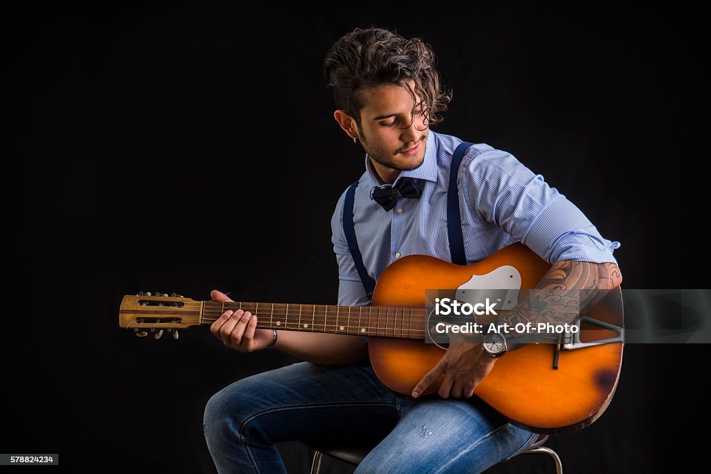 Bearded And Tattooed Man With Hairstyle Playing Guitar Stock Photo -  Download Image Now - iStock
