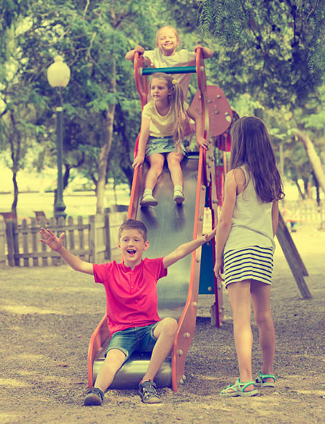 istock Kids playing on sliding toy 578824260
