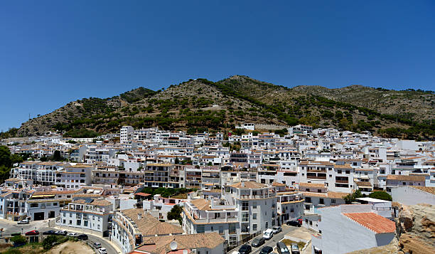 Mijas village. Costa del sol Spain. The beautiful Mijas pueblo ( village ) Also known as the white village. Nestled in the hills above Fuengirola on the Costa del sol Andalucia Spain. Taken on a hot and clear summers day under a deep blue sky. The picture is slightly polorised to add a little contrast. mijas pueblo stock pictures, royalty-free photos & images