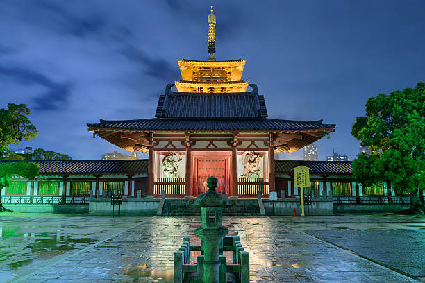 Shitennoji Temple Osaka Japan Osaka, Japan - August 24, 2015: The exterior of Shitennoji Temple at night as viewed from the Great South Gate. The temple was founded in 593 and is considered the first Buddhist and oldest officially administered temple in Japan. shitenno ji stock pictures, royalty-free photos & images