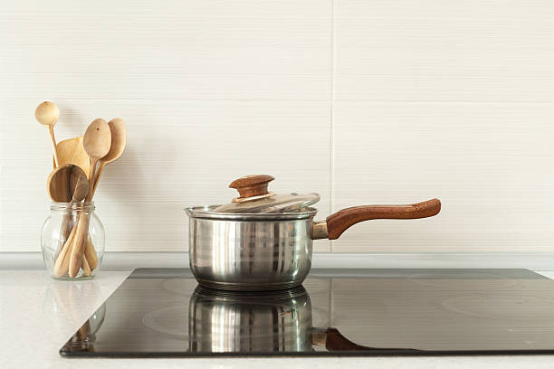 istock Wooden spoons in modern kitchen with induction stove 578827692