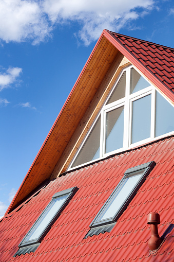 New red metal roof with attic windows (skylights) and Ventilation pipe for heat control