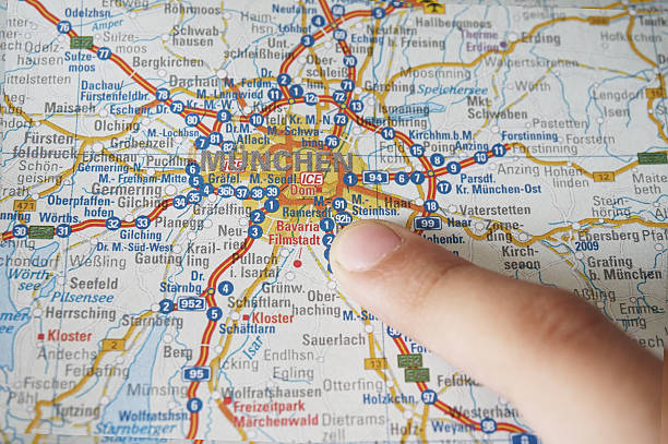 Close up of Munich map. Pray for Munich. A girl pointing the city of Munich