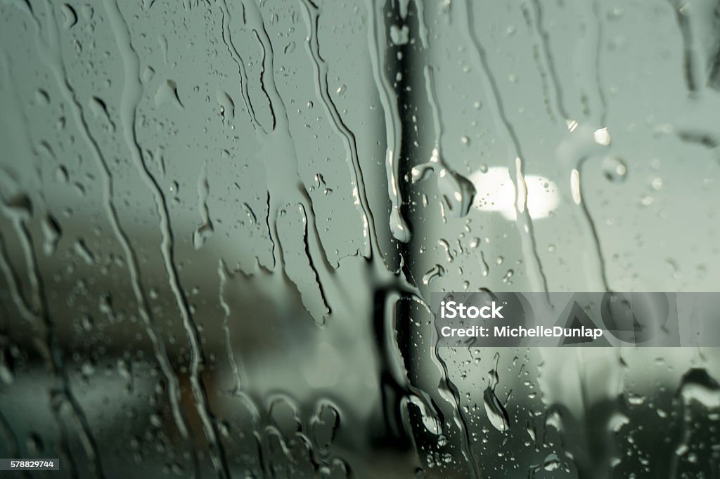 Rain Drops Running Down Window Close up of clear raindrops running down window Glass - Material Stock Photo