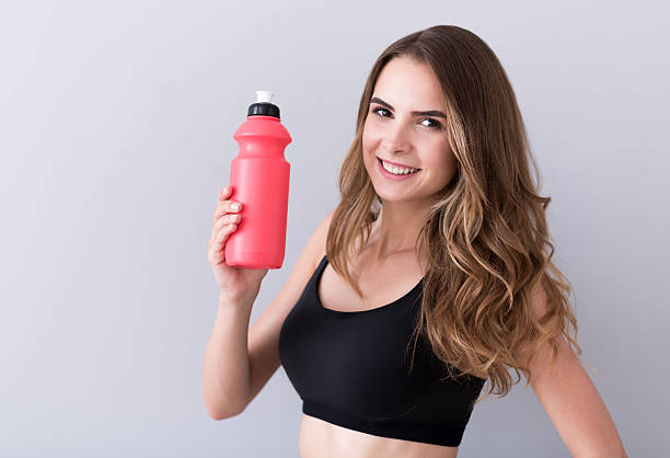 istock Pleasant cheerful woman drinking water 578830118