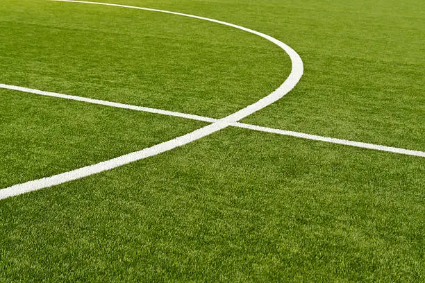 Lines on soccer field green grass. Abstract texture.