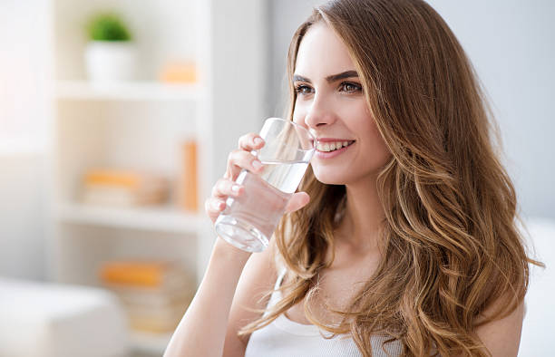 istock Positive woman drinking water 578831256